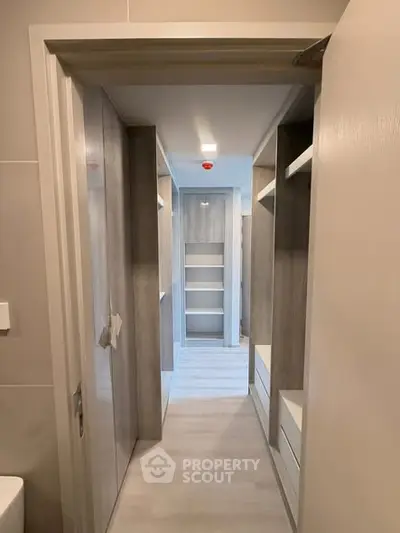 Modern walk-in closet with sleek shelving and ample storage space