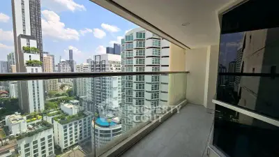Spacious balcony with stunning cityscape views in modern high-rise building.