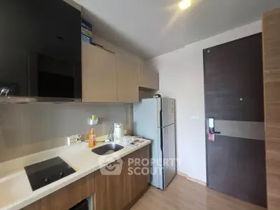 Modern kitchen with sleek cabinetry and built-in appliances in a stylish apartment.