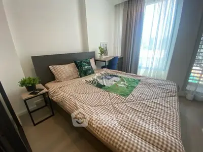 Cozy bedroom with modern decor and large window for natural light.