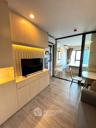 Modern living room with sleek design and city view, featuring a cozy seating area and stylish decor.