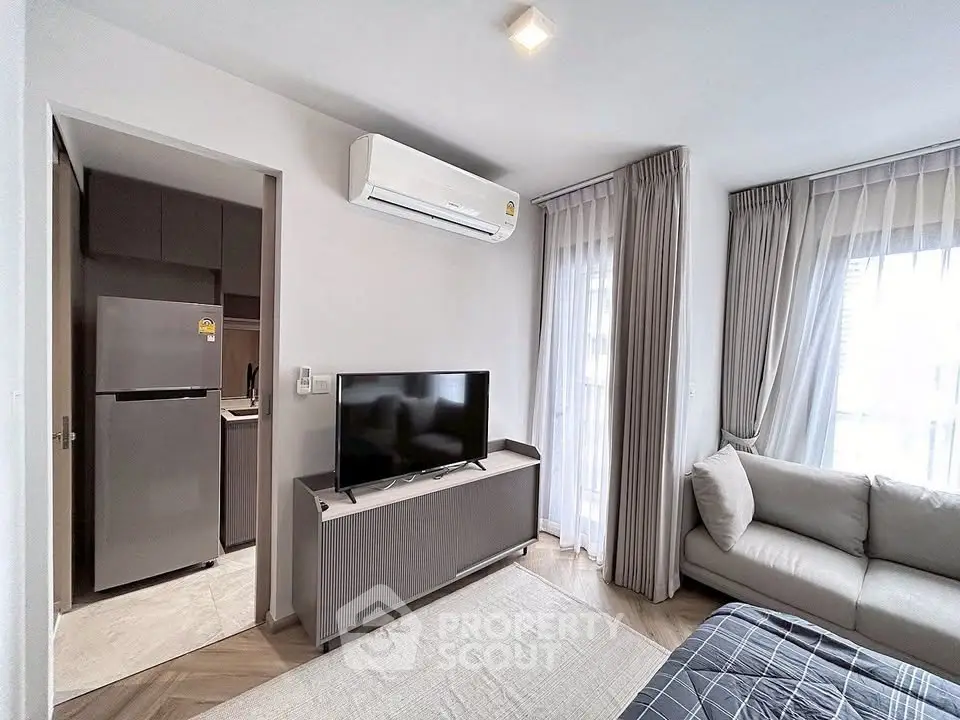 Modern living room with sleek furniture and open kitchen layout