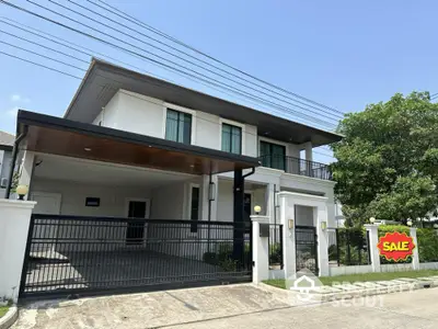 Modern two-story house with spacious driveway and sale sign in suburban neighborhood.