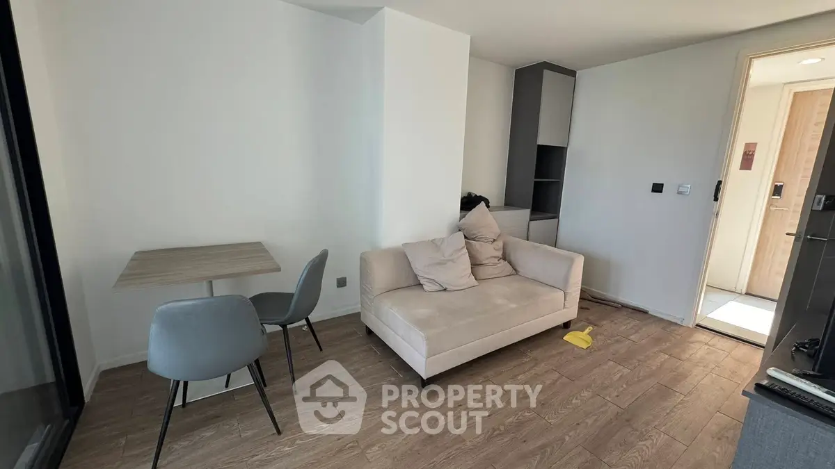 Modern living room with cozy sofa and dining area in stylish apartment