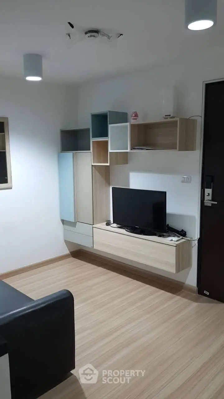 Modern living room with sleek wall-mounted TV unit and stylish shelving.