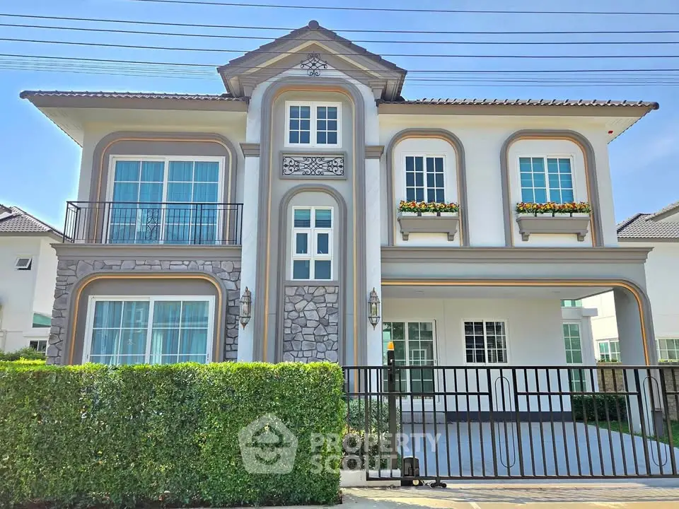 Elegant two-story house with stone accents and lush greenery, perfect for modern family living.
