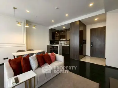 Modern living room with stylish decor and open kitchen layout in a contemporary apartment.
