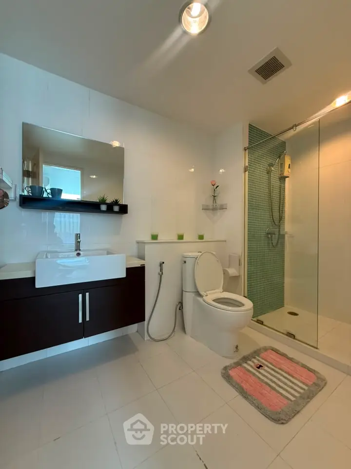 Modern bathroom with sleek fixtures and glass shower enclosure
