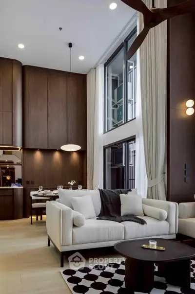 Luxurious modern living room with high ceilings and elegant decor in a stylish apartment.