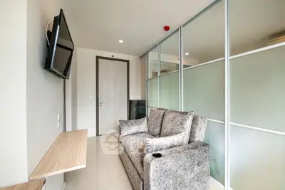 Modern living room with sleek design and wall-mounted TV in a stylish apartment.