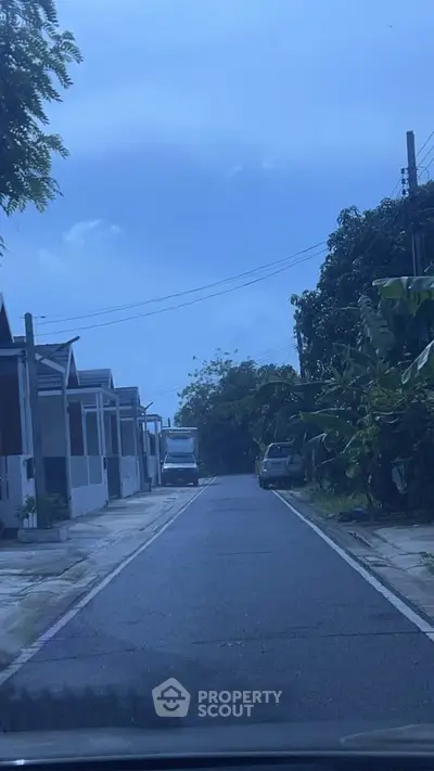 Charming residential street with modern houses and lush greenery, perfect for serene living.