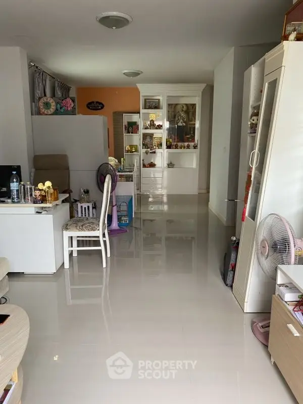 Spacious living area with modern decor and glossy flooring