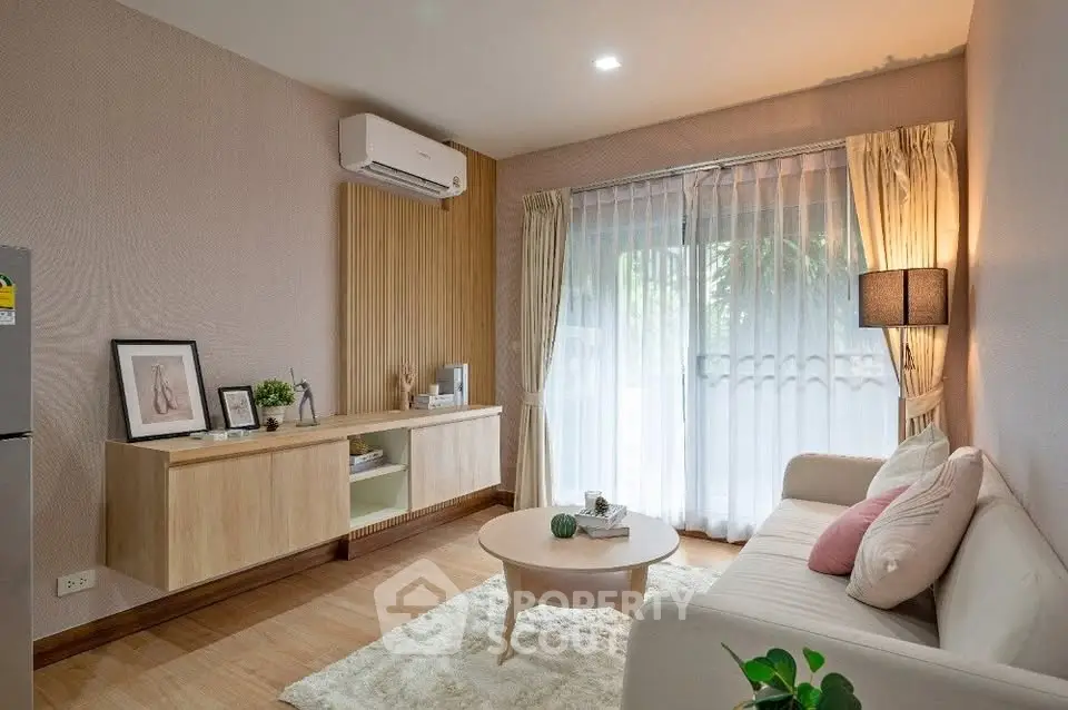 Charming living room with modern decor, cozy sofa, and natural light from large window.