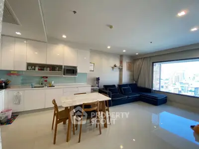 Spacious modern living room with open kitchen and city view