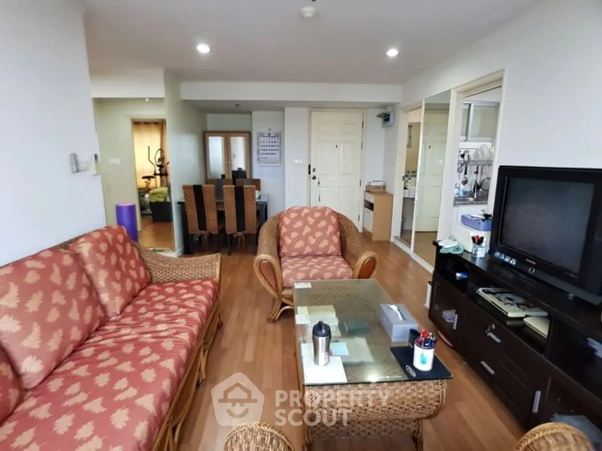 Spacious living room with elegant furniture and modern decor in a cozy apartment.