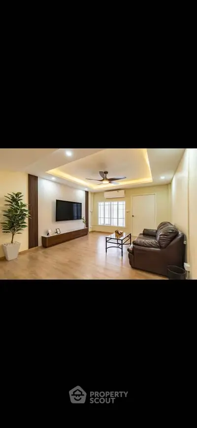 Spacious modern living room with sleek design and cozy seating area.
