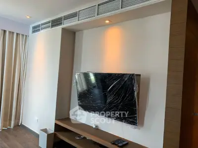 Modern living room with wall-mounted TV and sleek wooden furniture, perfect for contemporary living.