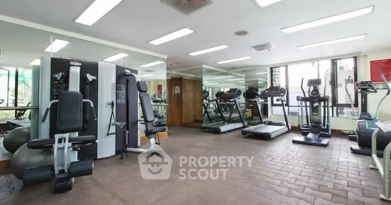Spacious modern gym with state-of-the-art fitness equipment and large mirrors.