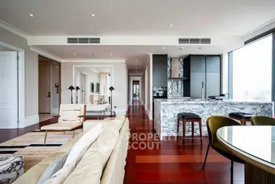 Luxurious open-plan living room with marble kitchen island and panoramic city views.