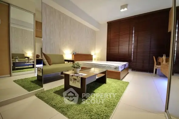 Modern bedroom with green accents and stylish furniture