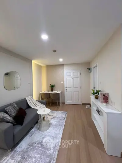 Modern living room with stylish decor and cozy seating area, perfect for relaxation and entertaining.