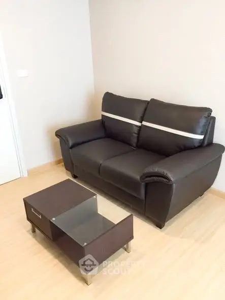 Cozy living room with modern brown leather sofa and sleek coffee table