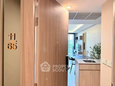 Modern apartment entrance with open kitchen and stylish interior design