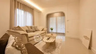 Elegant living room with cozy sofas and natural light, perfect for relaxation.