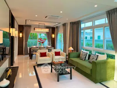Luxurious living room with elegant decor and large windows offering garden views