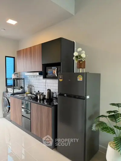 Modern kitchen with sleek appliances and stylish cabinetry in a contemporary home.