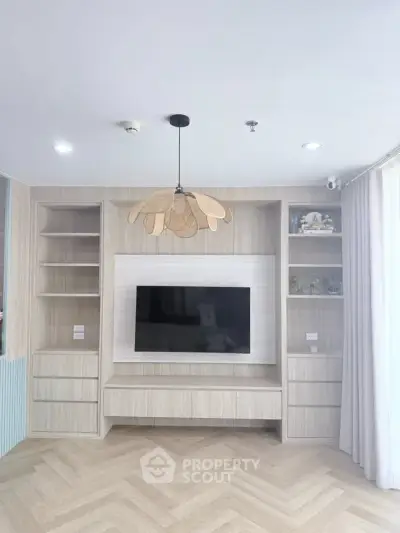 Modern living room with built-in TV unit and stylish lighting