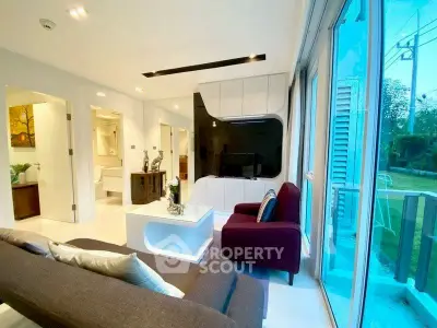 Modern living room with sleek design and large windows offering natural light.