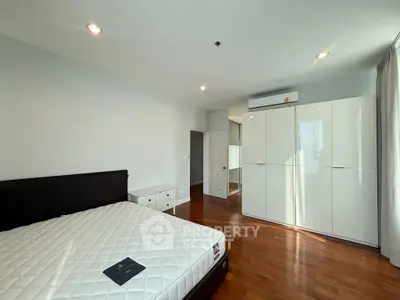 Spacious bedroom with modern furnishings and ample natural light