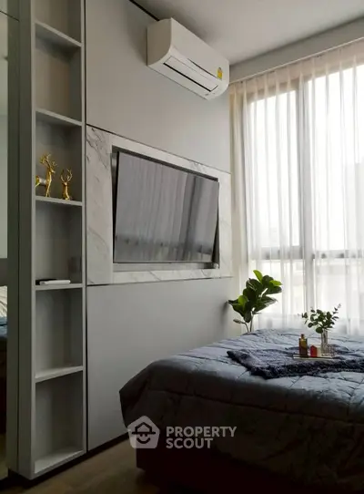 Modern bedroom with stylish decor and natural light
