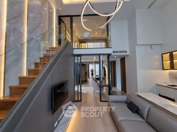 Luxurious modern living room with elegant staircase and open layout kitchen