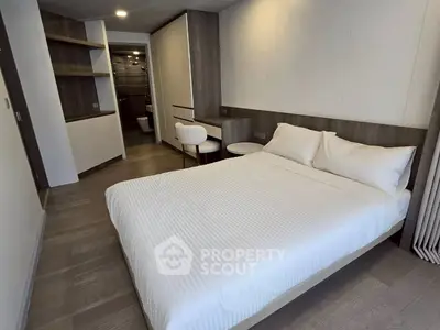 Modern bedroom with sleek design and cozy ambiance, featuring a comfortable bed and stylish furnishings.