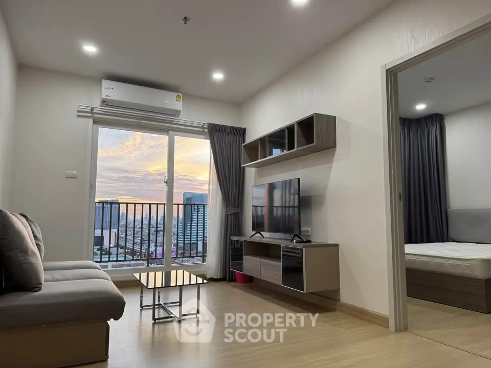 Modern living room with city view, featuring sleek furniture and a cozy atmosphere.