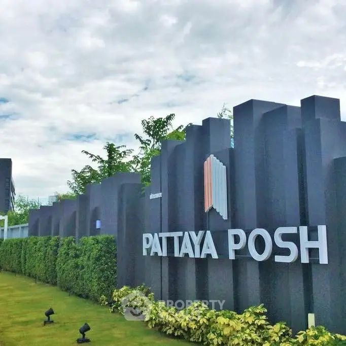 Luxurious Pattaya Posh condominium entrance with modern design and lush greenery