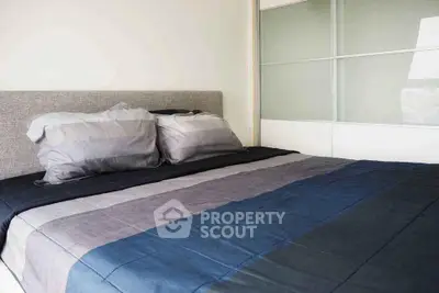 Modern bedroom with stylish bedding and sliding closet doors