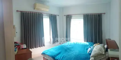 Cozy bedroom with blue bedding and ample natural light