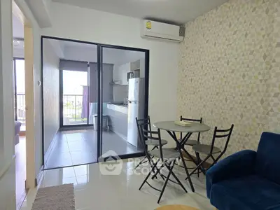 Modern apartment with open layout, featuring a cozy living area and stylish kitchen.