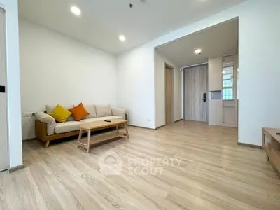 Spacious modern living room with wooden flooring and cozy furniture