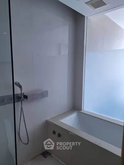 Modern bathroom with sleek design and built-in bathtub, perfect for relaxation.