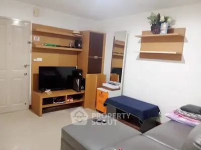 Cozy living room with modern furniture and entertainment center, perfect for relaxation.