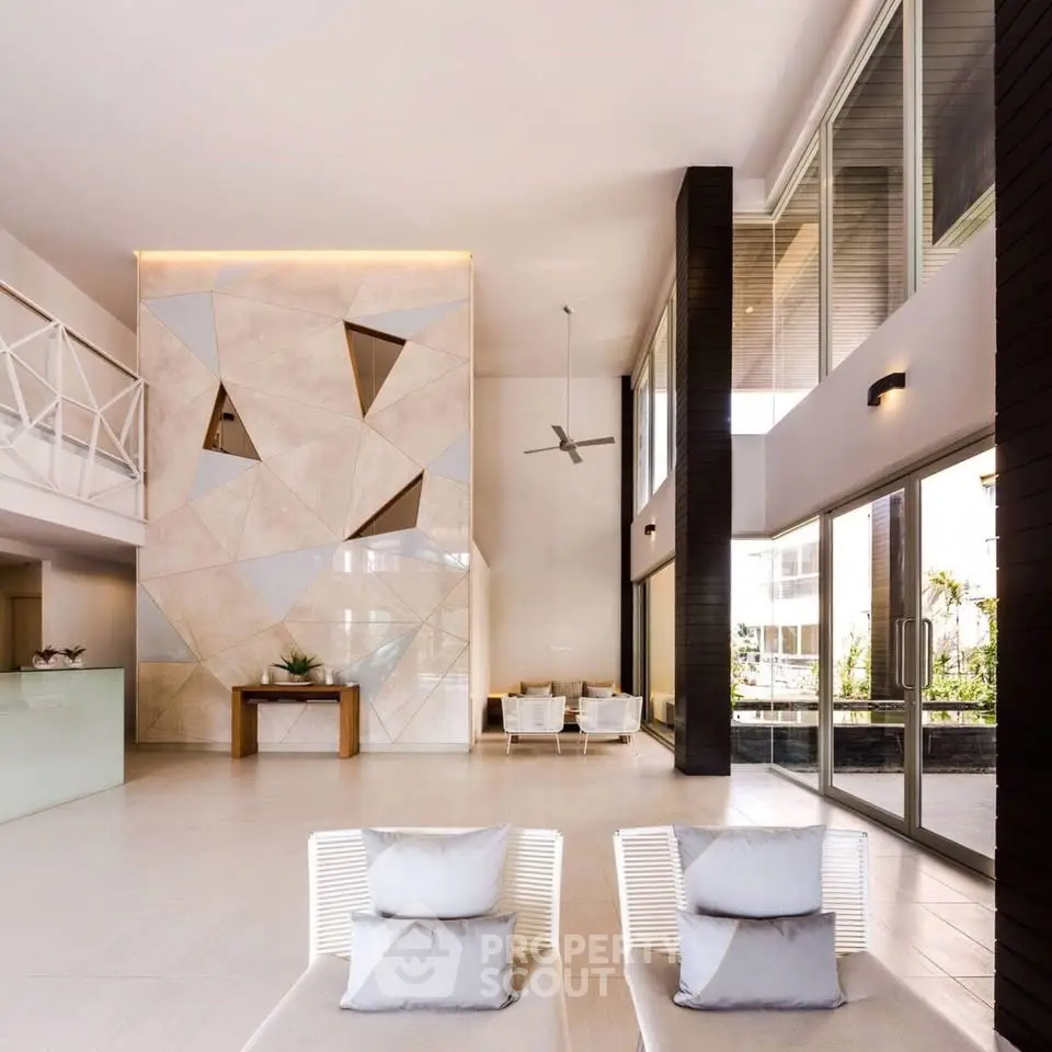 Luxurious modern lobby with high ceilings and stylish geometric wall design