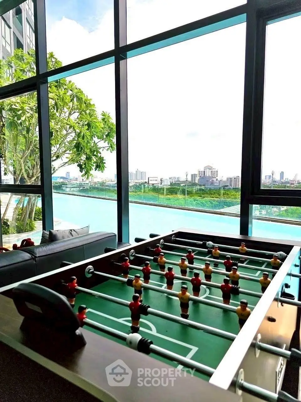 Luxurious high-rise apartment with stunning city view and foosball table