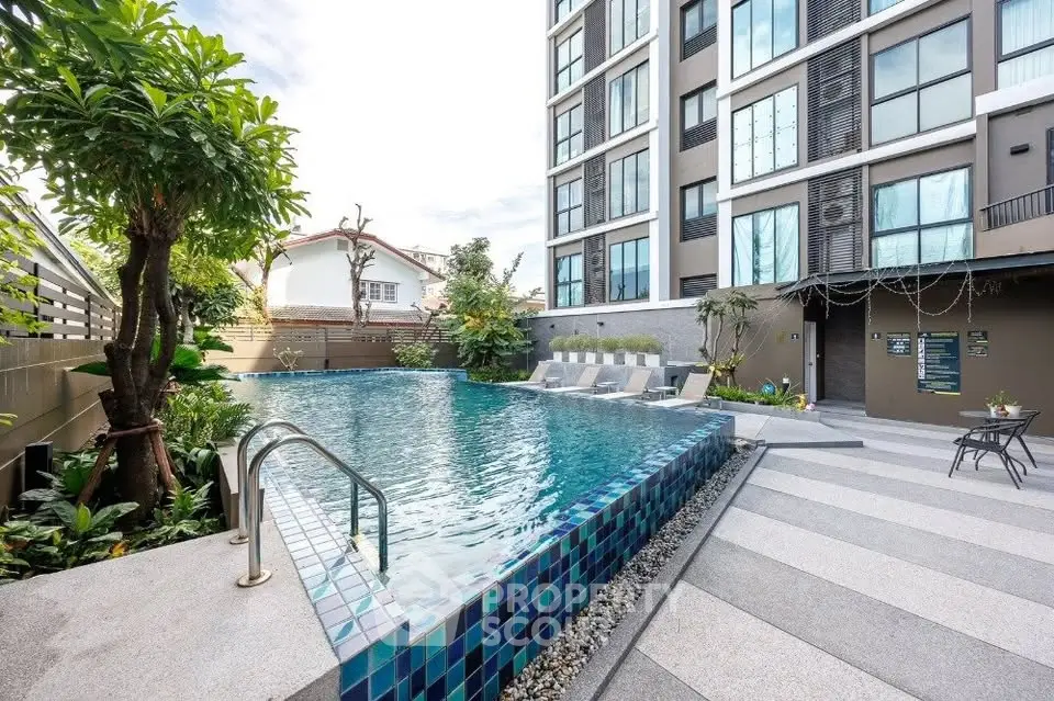 Luxurious apartment building with a stunning outdoor pool and modern design.