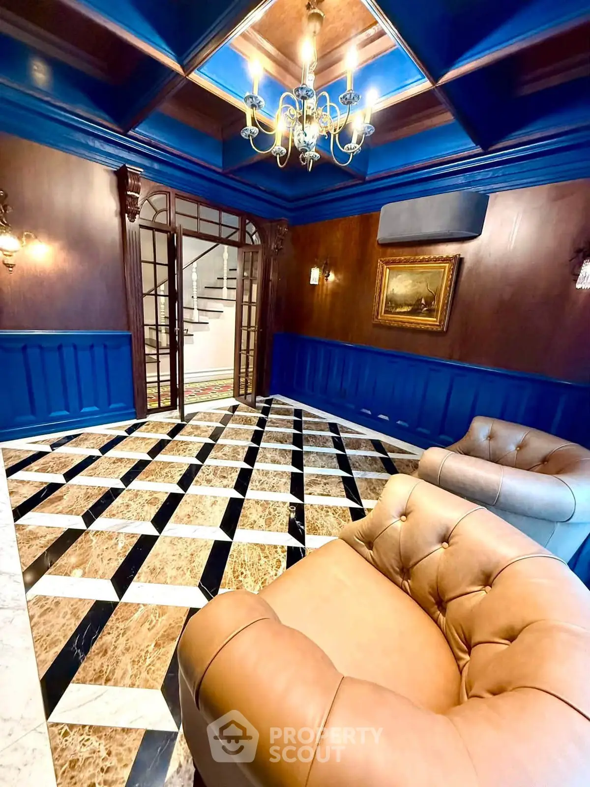 Luxurious lobby with elegant decor and plush seating in a sophisticated building entrance.