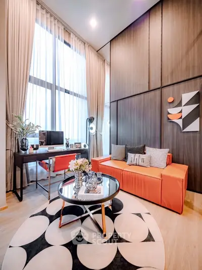 Modern living room with high ceilings, stylish decor, and large windows for natural light.