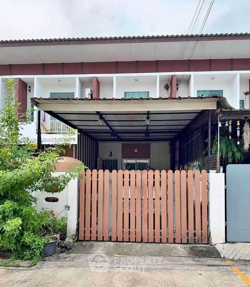 Charming townhouse with covered parking and lush greenery in a serene neighborhood.